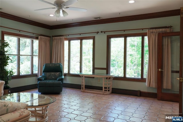 living room with a baseboard radiator, healthy amount of natural light, ceiling fan, baseboards, and ornamental molding