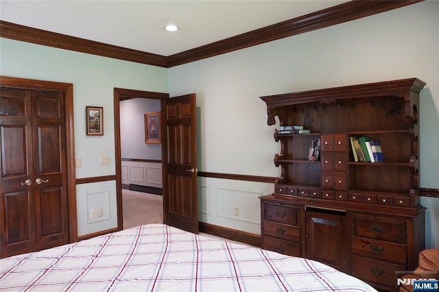 bedroom with crown molding, wainscoting, and recessed lighting