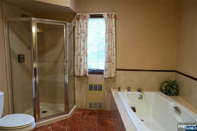 bathroom featuring radiator, a shower stall, and toilet