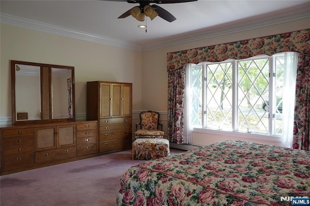 bedroom featuring ornamental molding, carpet floors, and a ceiling fan