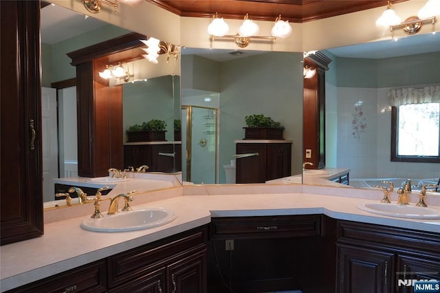 bathroom with a shower stall, vanity, a bath, and crown molding
