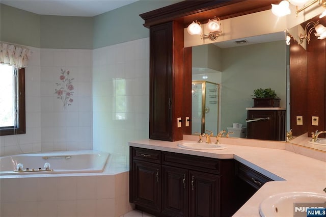 full bath featuring a bath, a stall shower, and vanity