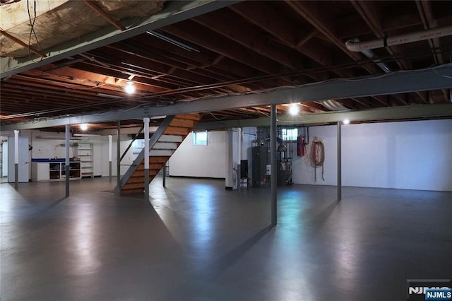 below grade area featuring stairway and water heater