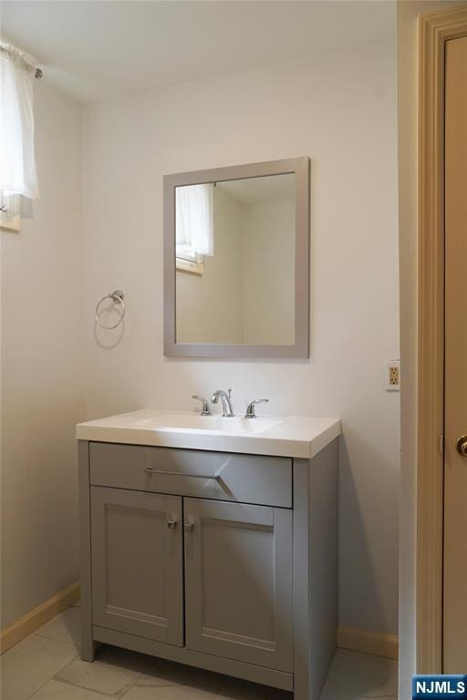 bathroom with baseboards and vanity