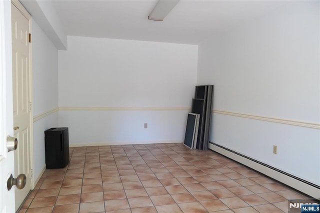 spare room featuring a baseboard heating unit