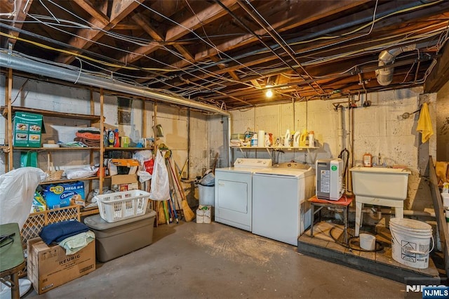unfinished below grade area with washer and clothes dryer and a sink
