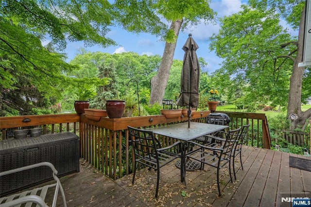 wooden deck featuring outdoor dining space