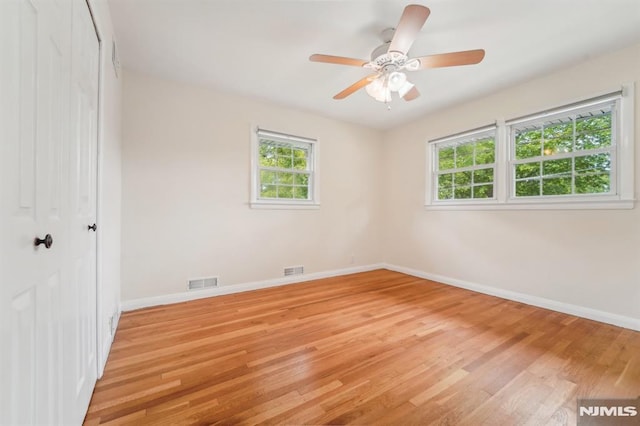 7 Swan Ter, Wayne, NJ 07470 - unfurnished bedroom featuring light wood-type flooring, multiple windows, and baseboards