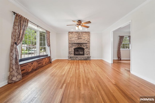 7 Swan Ter, Wayne, NJ 07470 - unfurnished living room with light wood finished floors, a ceiling fan, plenty of natural light, a fireplace, and ornamental molding
