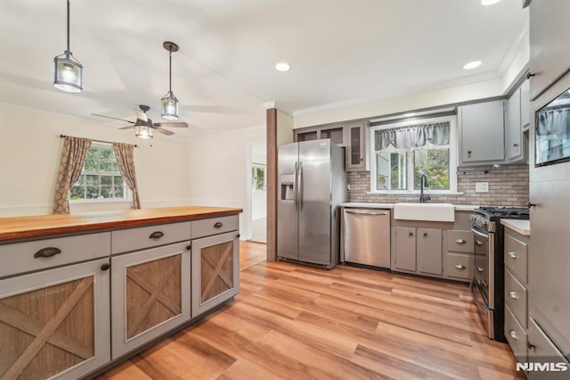 7 Swan Ter, Wayne, NJ 07470 - kitchen featuring stainless steel appliances, ornamental molding, a sink, gray cabinets, and pendant lighting
