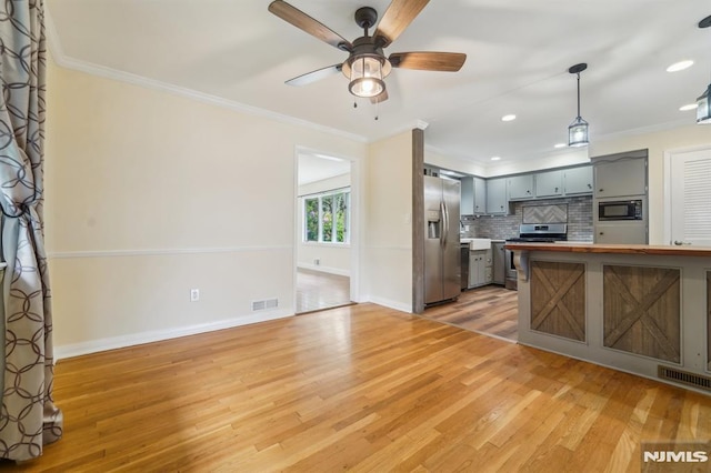 7 Swan Ter, Wayne, NJ 07470 - kitchen featuring stainless steel appliances, gray cabinetry, crown molding, light wood-style floors, and recessed lighting