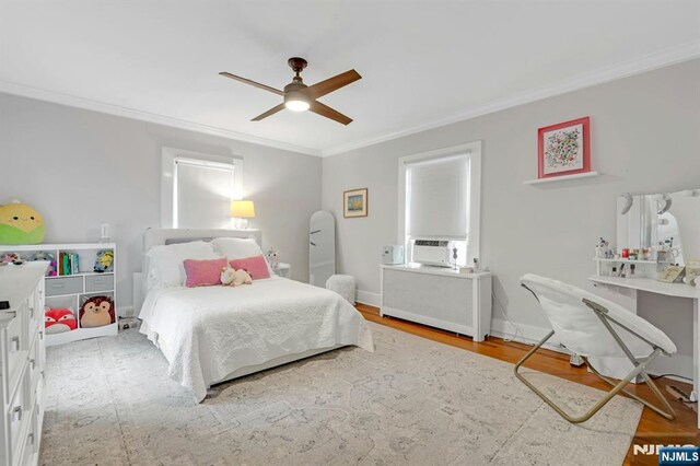 121 Beverly Rd, Montclair, NJ 07043 - bedroom featuring ornamental molding, radiator, ceiling fan, wood finished floors, and cooling unit