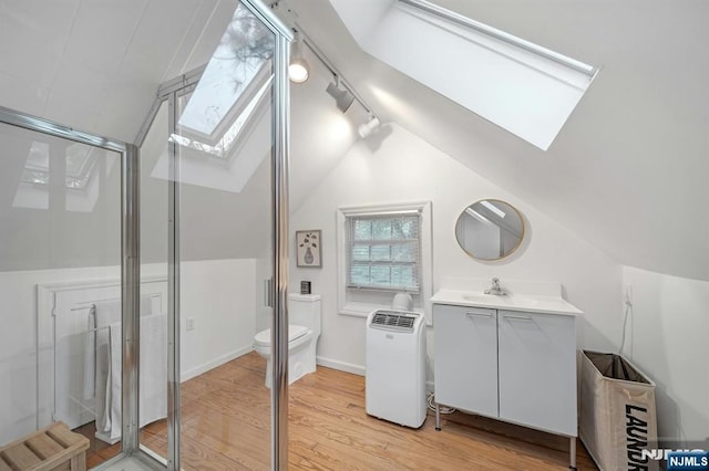 121 Beverly Rd, Montclair, NJ 07043 - full bathroom with a skylight, lofted ceiling, a stall shower, wood finished floors, and vanity