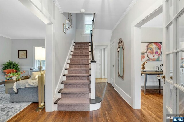 121 Beverly Rd, Montclair, NJ 07043 - stairs with wood finished floors and crown molding