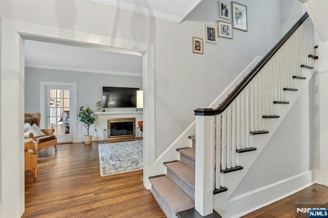 121 Beverly Rd, Montclair, NJ 07043 - stairs featuring crown molding, wood finished floors, baseboards, and a glass covered fireplace