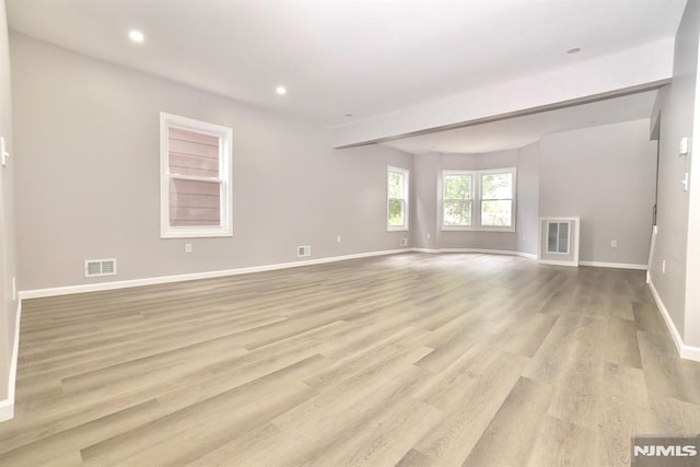 unfurnished room featuring baseboards, light wood finished floors, and recessed lighting