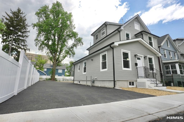 view of property exterior with fence