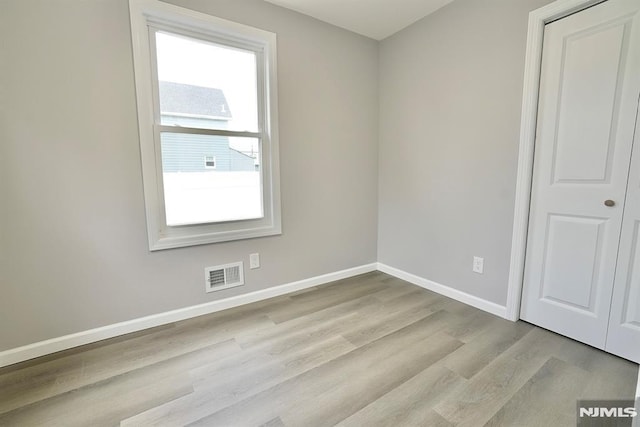 unfurnished room featuring wood finished floors and baseboards