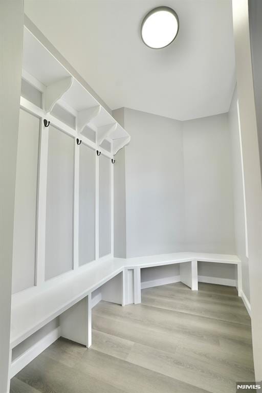 mudroom featuring wood finished floors and baseboards