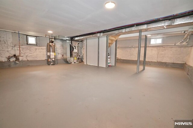basement with gas water heater and heating unit