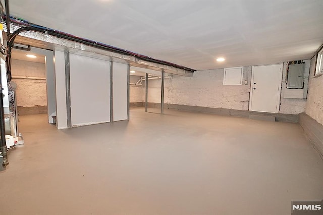 unfinished basement featuring electric panel