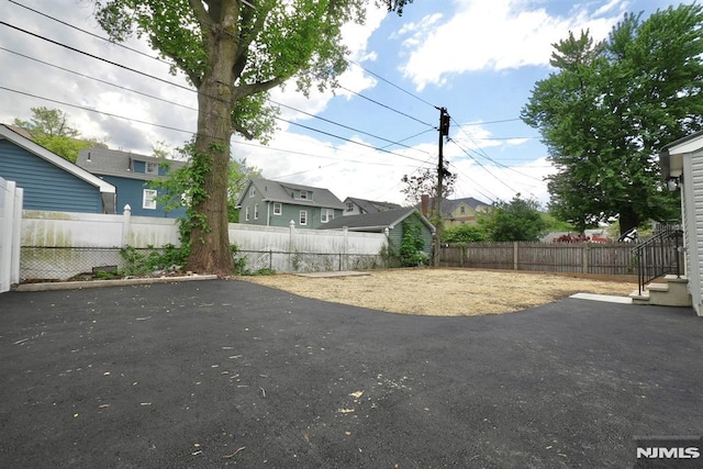 fenced backyard with a patio area