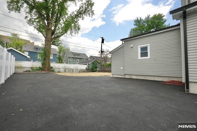 view of patio with fence and a residential view