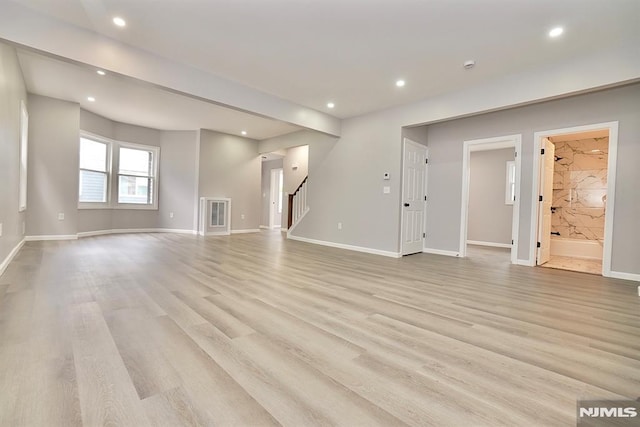 unfurnished living room with stairs, light wood-type flooring, recessed lighting, and baseboards