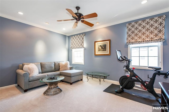 living area featuring baseboards, carpet floors, recessed lighting, a ceiling fan, and crown molding