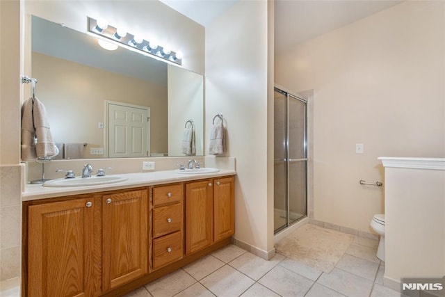 full bath with tile patterned floors, toilet, and a shower stall