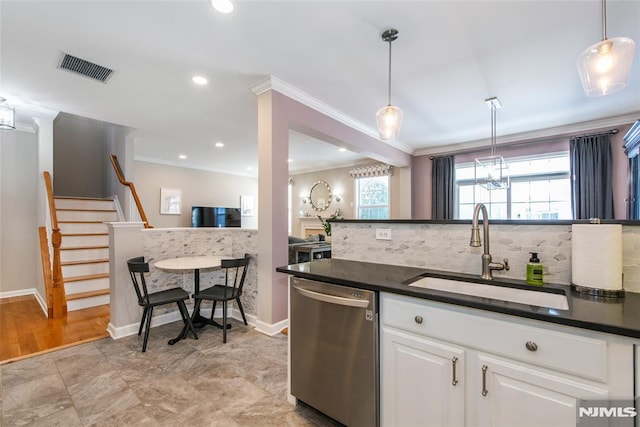 kitchen with stainless steel dishwasher, a sink, dark countertops, ornamental molding, and tasteful backsplash