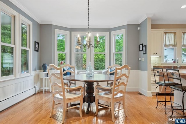 125 Bellevue Ave, Montclair, NJ 07043 - dining area with a baseboard radiator, light wood-type flooring, a wainscoted wall, a chandelier, and crown molding