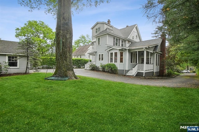 125 Bellevue Ave, Montclair, NJ 07043 - back of house with a chimney and a lawn