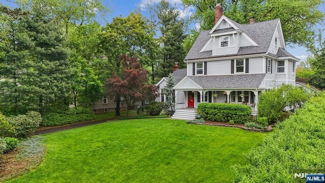 125 Bellevue Ave, Montclair, NJ 07043 - view of front of house featuring a shingled roof, covered porch, a front lawn, and a chimney