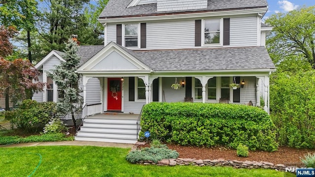 125 Bellevue Ave, Montclair, NJ 07043 - view of front facade with roof with shingles, covered porch, and a front lawn