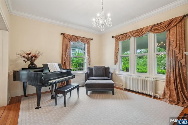 125 Bellevue Ave, Montclair, NJ 07043 - sitting room with radiator heating unit, a chandelier, ornamental molding, hardwood / wood-style flooring, and baseboards