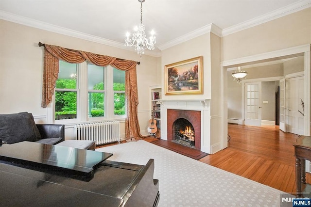 125 Bellevue Ave, Montclair, NJ 07043 - living room with radiator, wood finished floors, baseboard heating, a chandelier, and ornamental molding