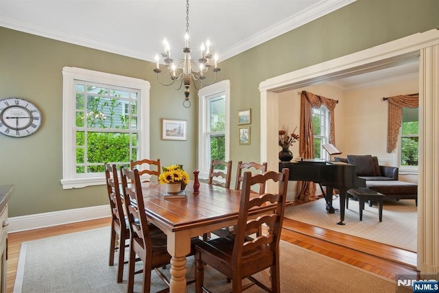 125 Bellevue Ave, Montclair, NJ 07043 - dining room with plenty of natural light, wood finished floors, ornamental molding, a chandelier, and baseboards