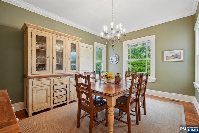 125 Bellevue Ave, Montclair, NJ 07043 - dining space featuring a chandelier, crown molding, baseboards, and wood finished floors