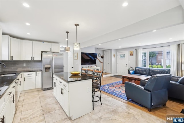 520 Elm St, Roselle Park, NJ 07204 - kitchen with open floor plan, stainless steel fridge with ice dispenser, a sink, dark countertops, and recessed lighting
