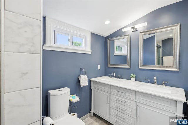 520 Elm St, Roselle Park, NJ 07204 - full bath featuring lofted ceiling, toilet, baseboards, double vanity, and wood finished floors