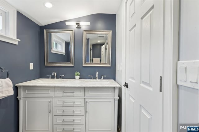 520 Elm St, Roselle Park, NJ 07204 - bathroom featuring lofted ceiling, double vanity, and recessed lighting