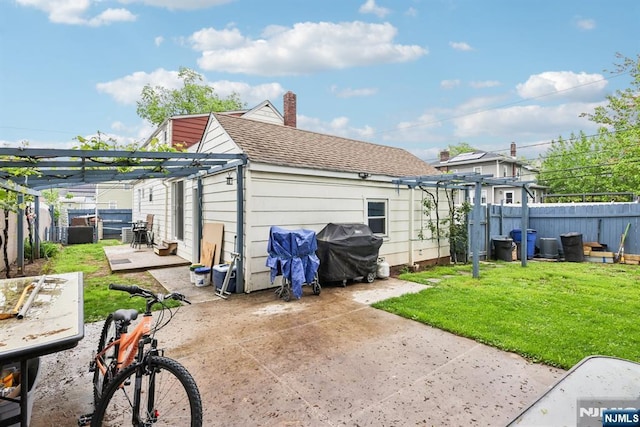 520 Elm St, Roselle Park, NJ 07204 - back of property with a pergola, a patio, a shingled roof, and a chimney