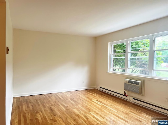 109 N Maple, Park Ridge, NJ 07656 - spare room featuring light wood-style floors, an AC wall unit, baseboard heating, and baseboards