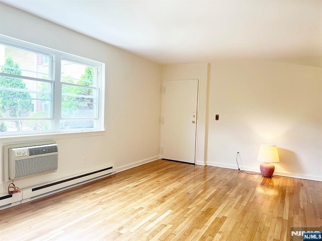 109 N Maple, Park Ridge, NJ 07656 - spare room with a baseboard radiator, light wood finished floors, baseboards, and a wall mounted AC