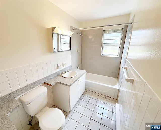 109 N Maple, Park Ridge, NJ 07656 - bathroom featuring tile walls, tile patterned floors, toilet, vanity, and bathing tub / shower combination