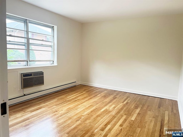 109 N Maple, Park Ridge, NJ 07656 - unfurnished room featuring baseboard heating, light wood-style floors, an AC wall unit, and baseboards