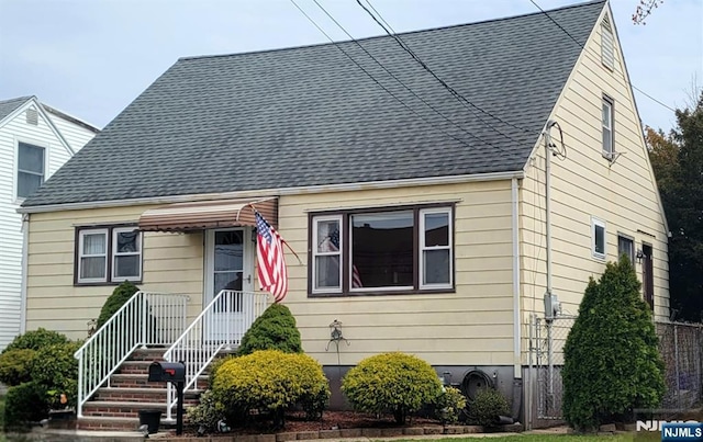 view of front of home with roof with shingles