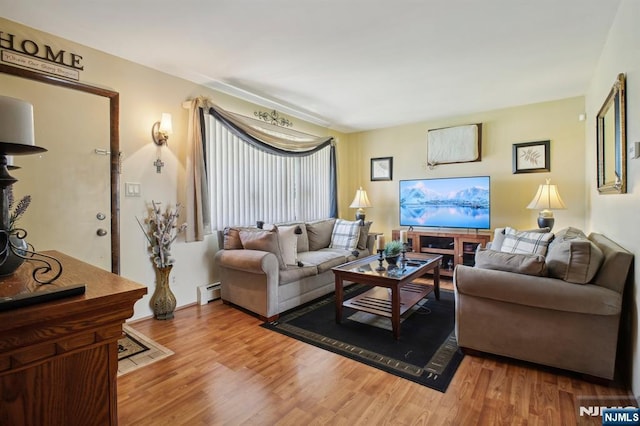 living area featuring a baseboard radiator and wood finished floors