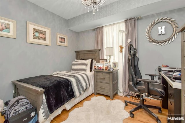 127 Brill St, Newark, NJ 07105 - bedroom featuring light wood finished floors, a desk, and a chandelier